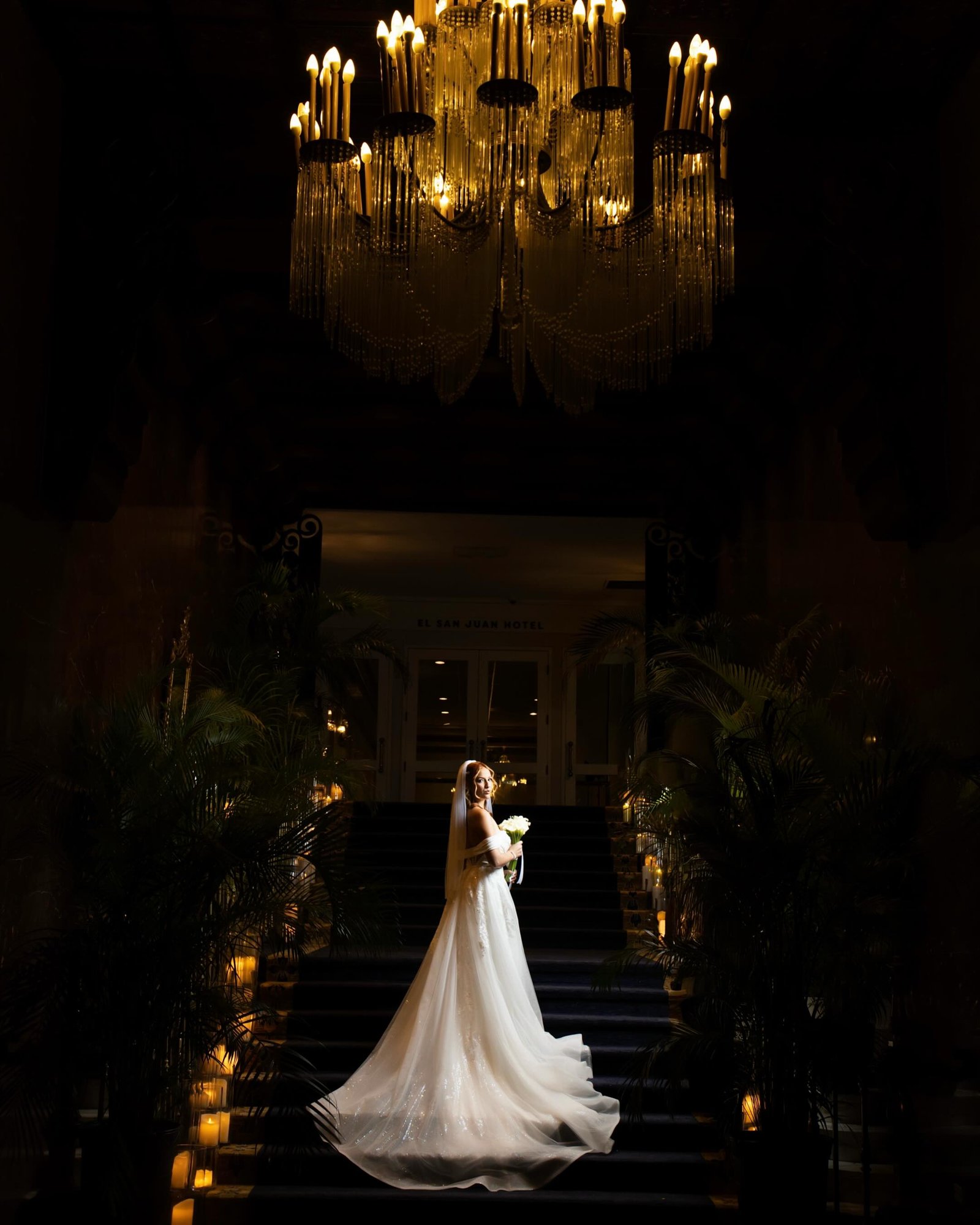 Bride beneath the chandelier at El San Juan Hotel